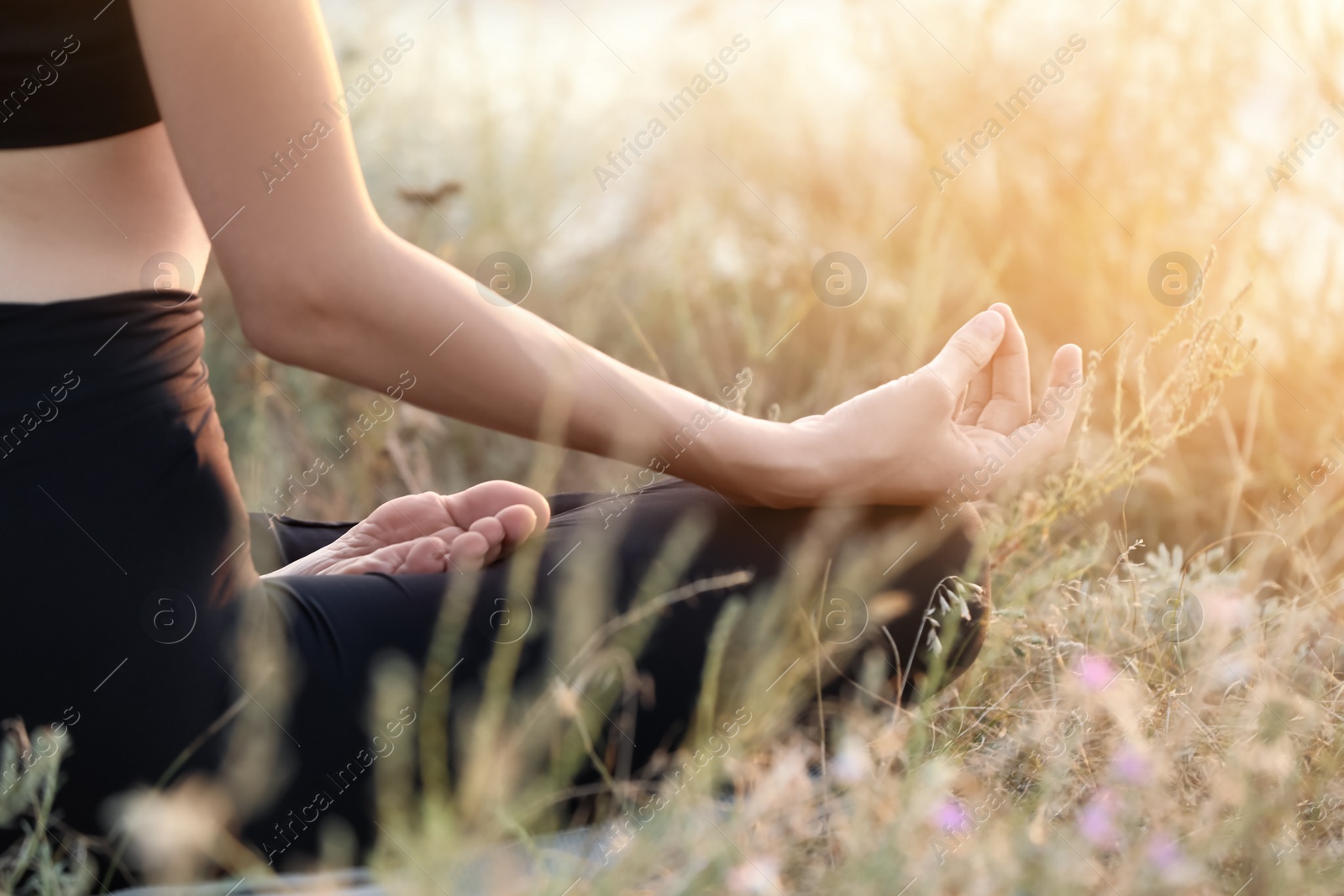 Photo of Young woman meditating on hill, closeup view