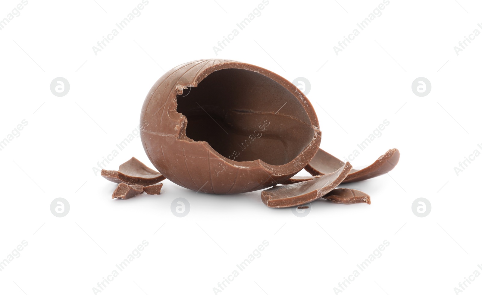 Photo of Broken milk chocolate egg on white background