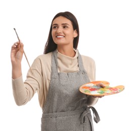 Young woman drawing with brush on white background