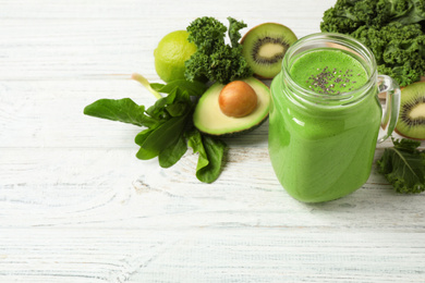 Photo of Tasty fresh kale smoothie on white wooden table