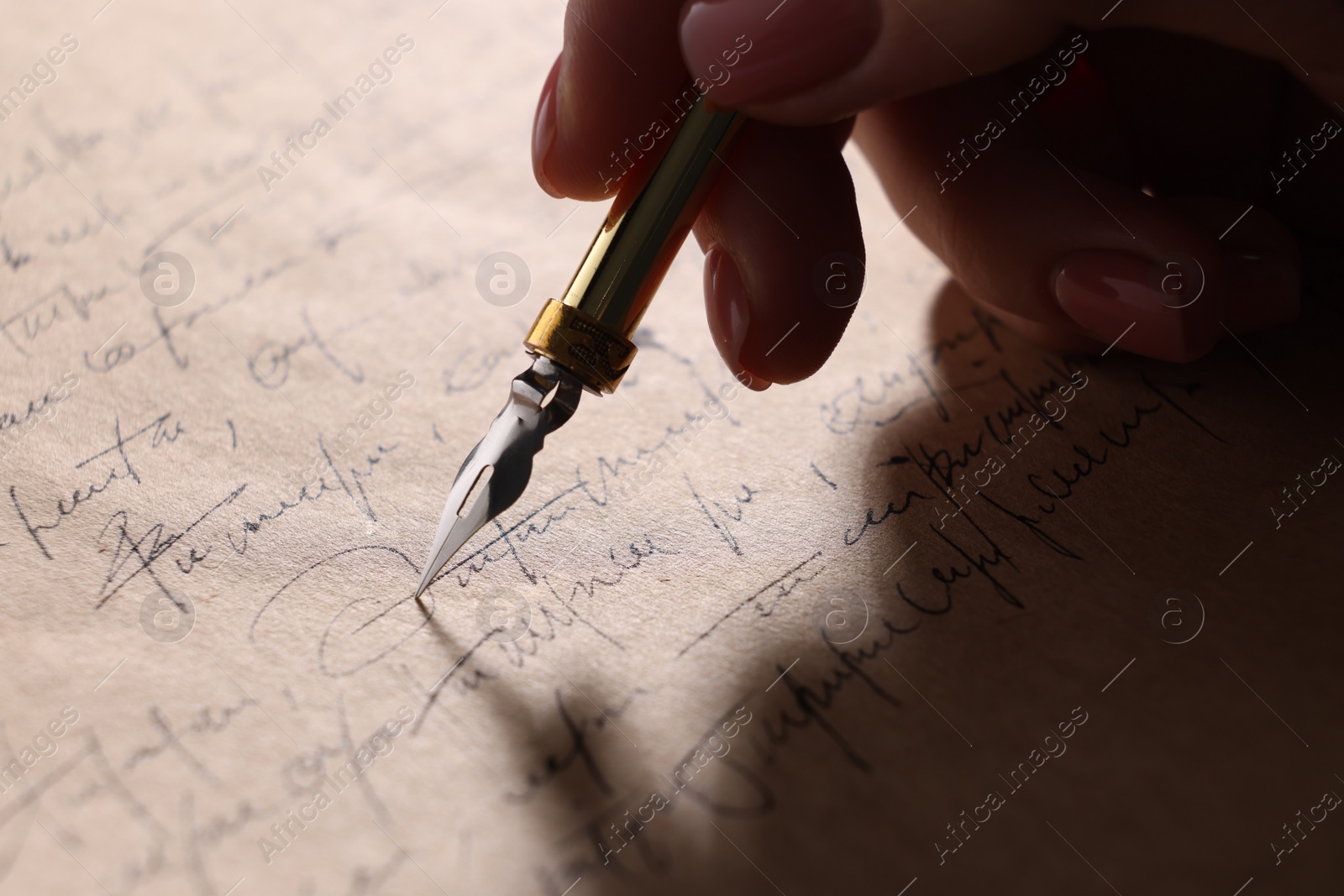 Photo of Woman writing letter with fountain pen, closeup