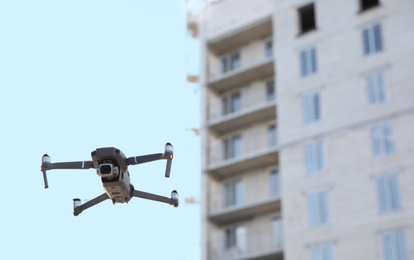 Modern drone flying at building site. Aerial survey