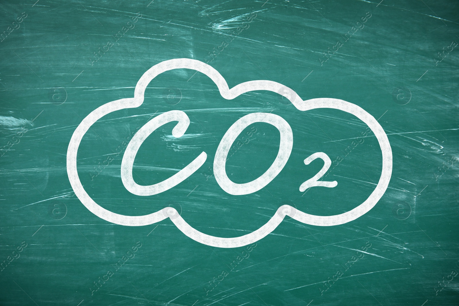 Image of Reduce carbon emissions. Chemical formula CO2 on green chalkboard