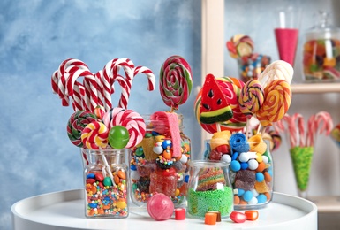 Composition with many different candies on table