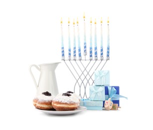 Hanukkah celebration. Menorah with candles, gift boxes, donuts, wooden dreidels and jug isolated on white