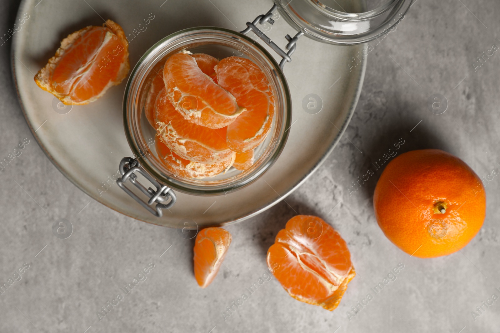 Photo of Fresh ripe tangerines on grey table, flat lay