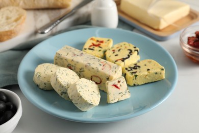 Photo of Different types of tasty butter on white table, closeup