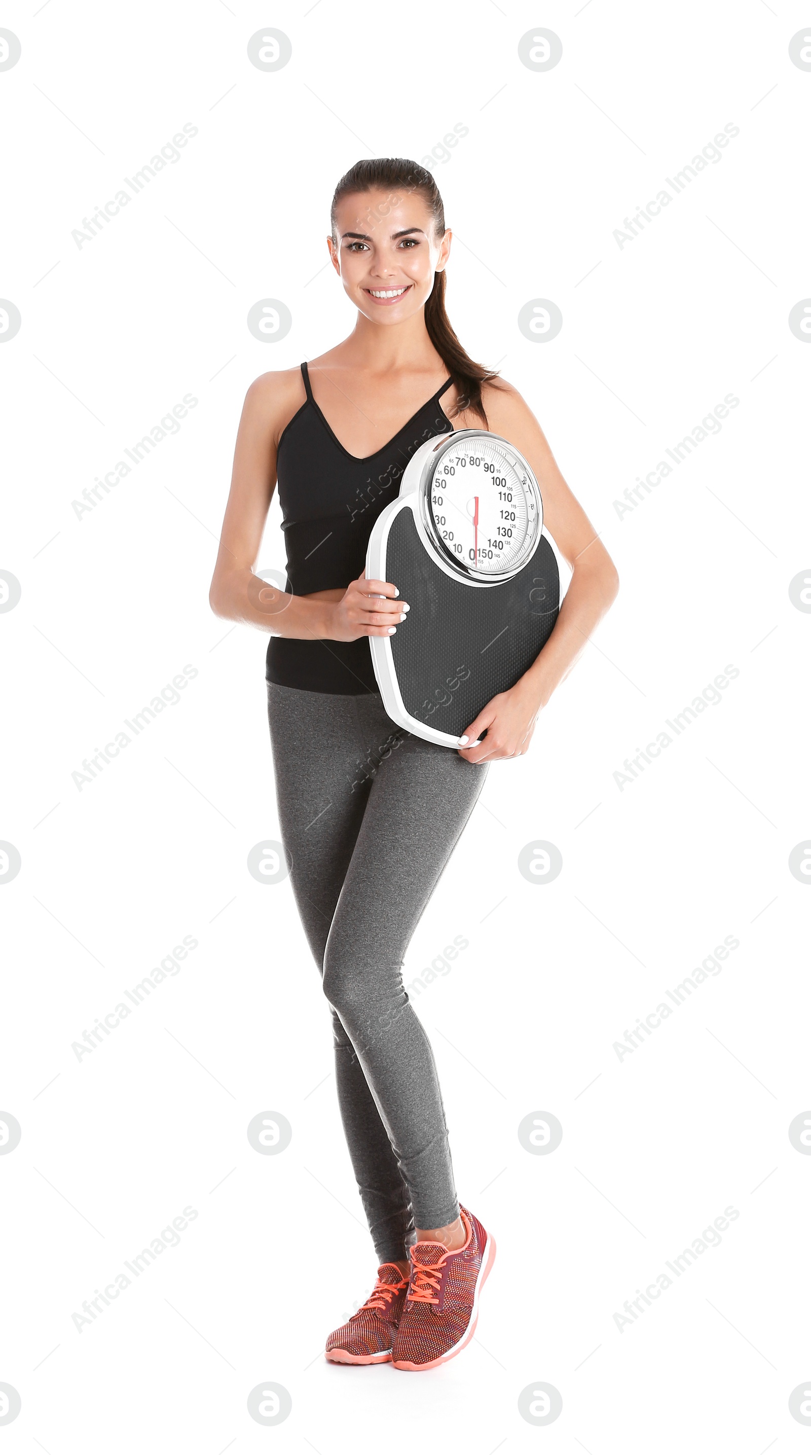 Photo of Happy young woman with scales on white background. Weight loss motivation