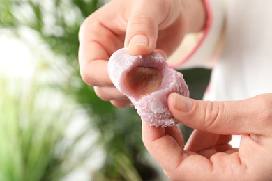 Photo of Woman with delicious mochi, closeup. Japanese cuisine