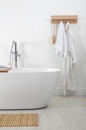 Photo of Stylish bathroom interior with modern white tub