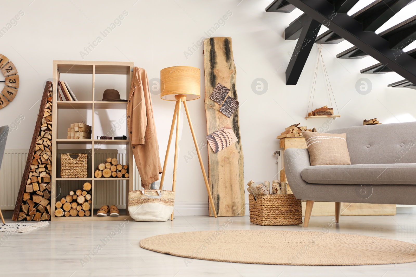 Photo of Stylish room interior with firewood as decorative element