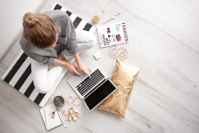 Photo of Female blogger with laptop indoors, top view