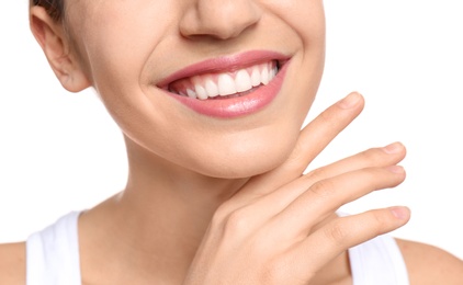 Young woman with beautiful smile on white background, closeup. Teeth whitening