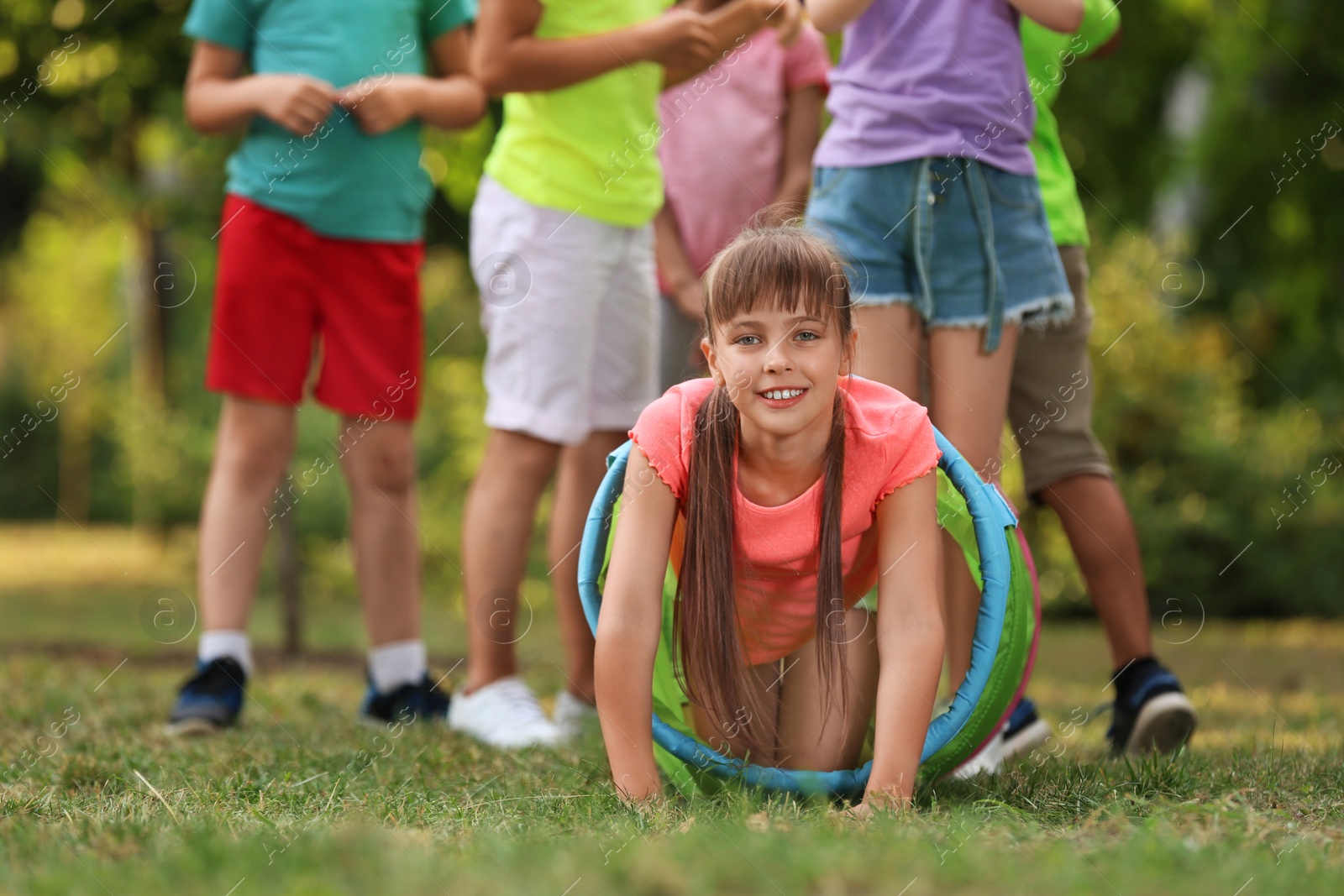 Photo of Cute little child playing with friends in park