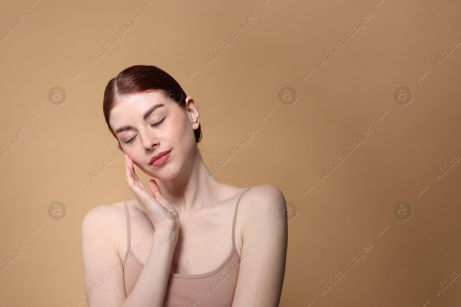 Photo of Portrait of beautiful woman on beige background. Space for text