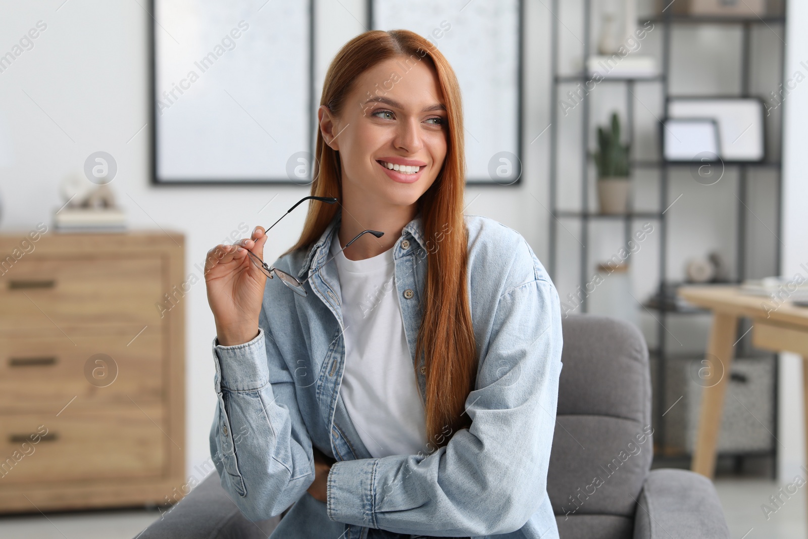 Photo of Portrait of beautiful smiling young woman. Happy lady with red hair at home