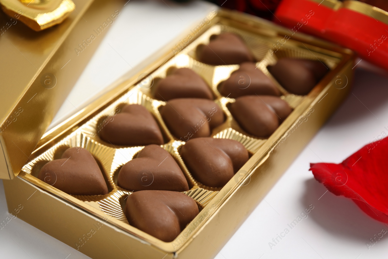 Photo of Tasty heart shaped chocolate candies on white background, closeup. Valentine's day celebration