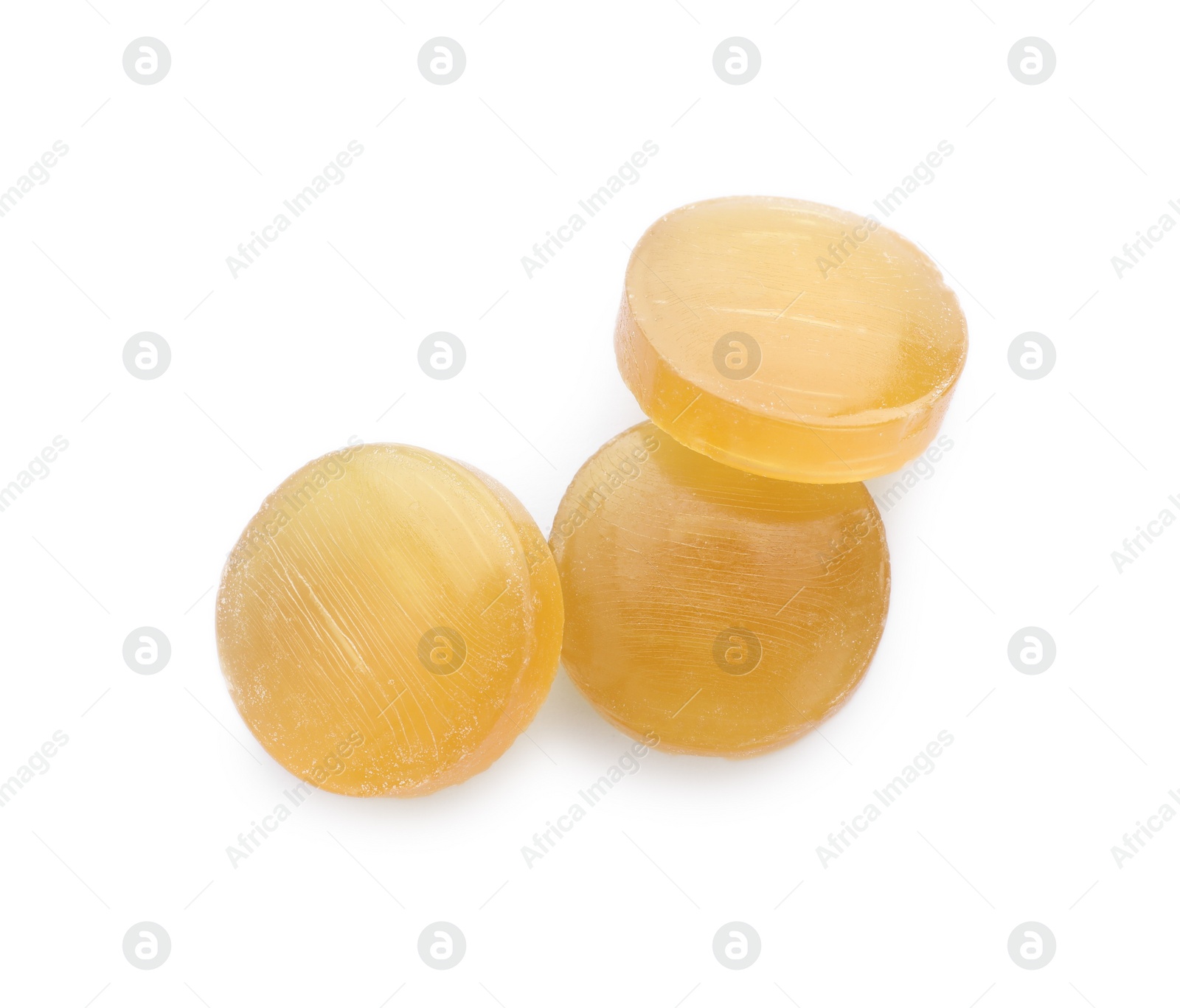 Photo of Yellow cough drops on white background, top view