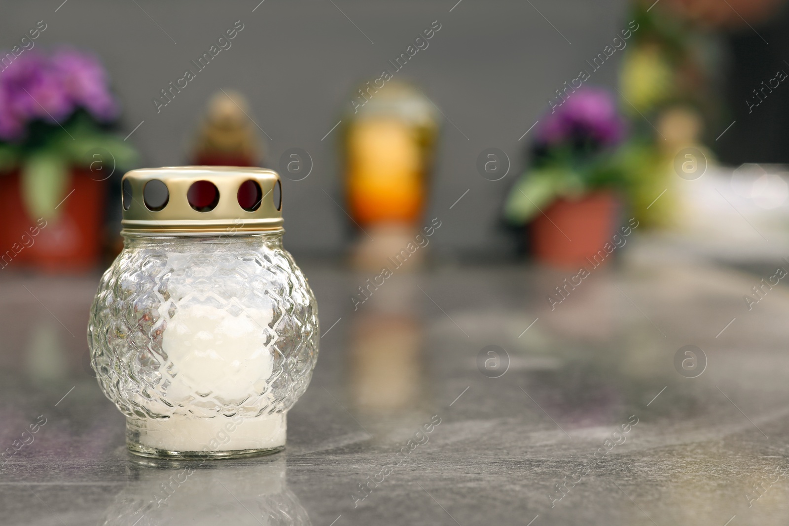Photo of White grave lantern on granite tombstone outdoors, space for text