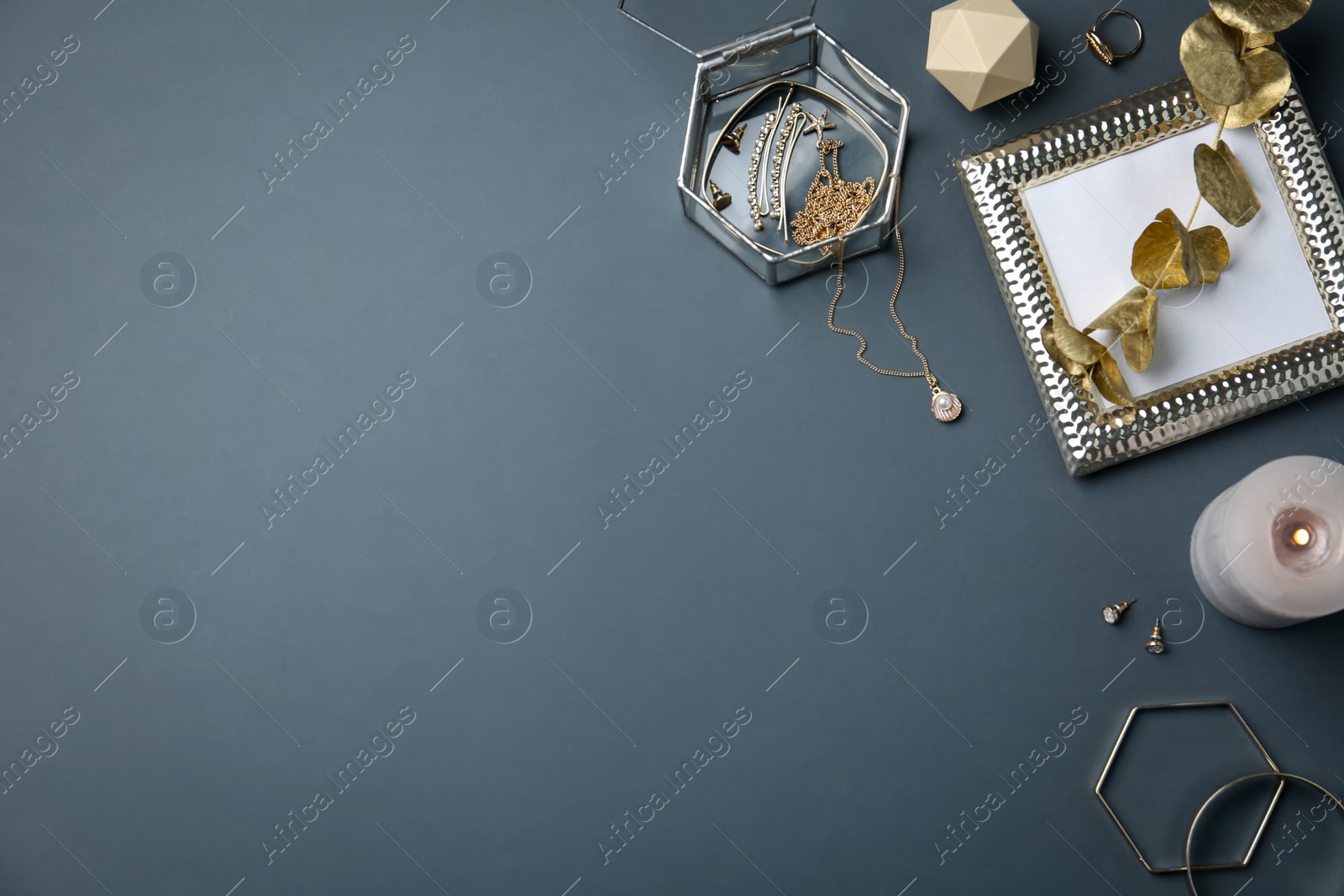 Photo of Flat lay composition with stylish accessories and decor elements on dark grey background. Space for text