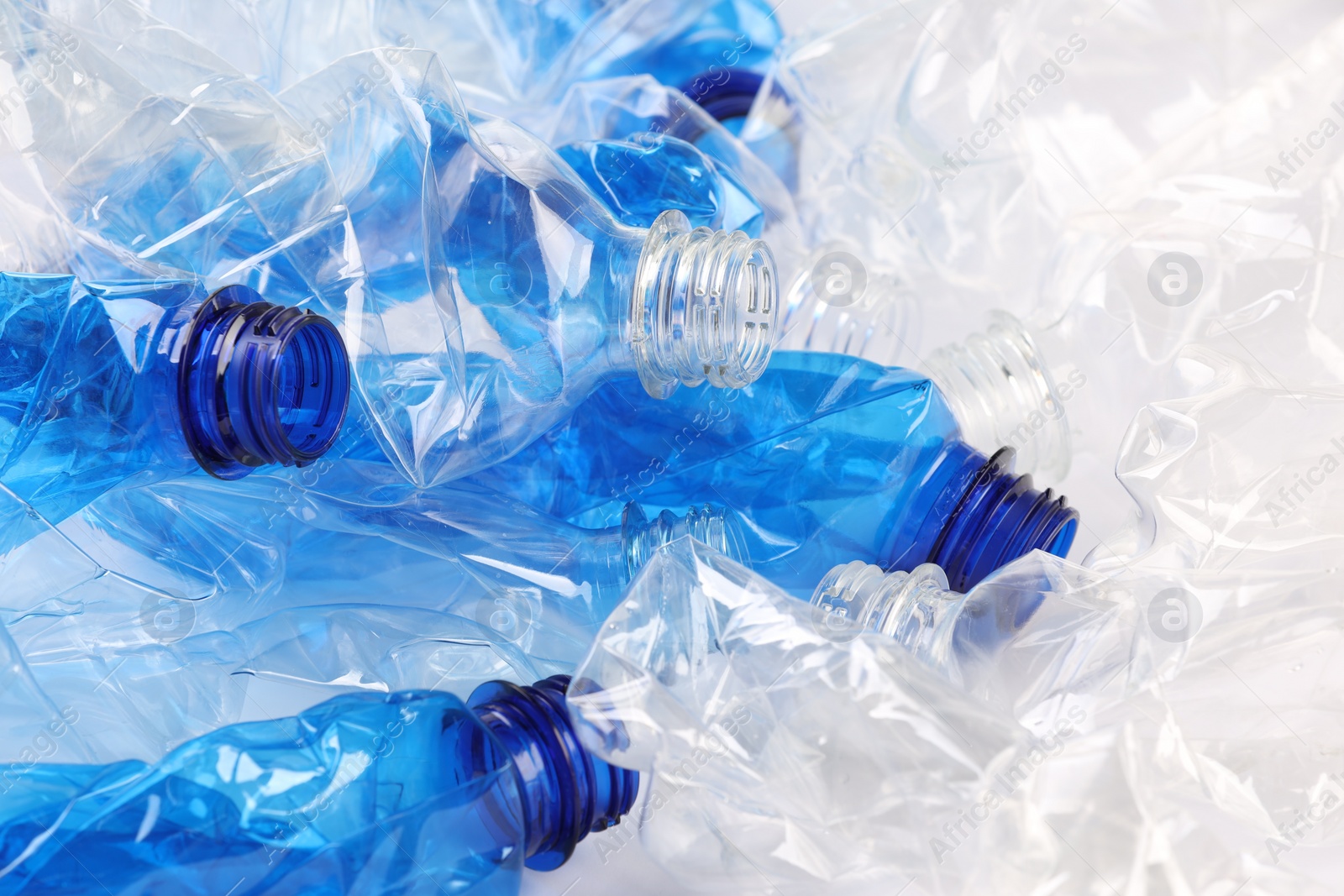 Photo of Crumpled disposable plastic bottles as background, closeup