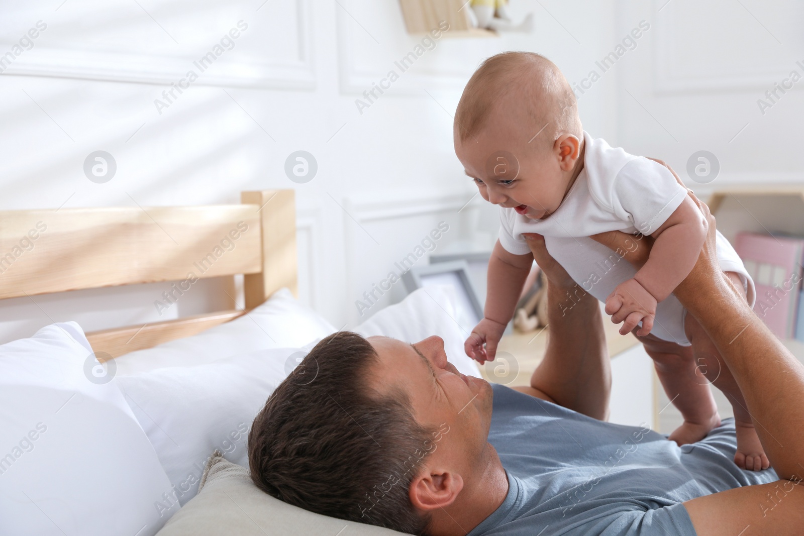 Photo of Father with his cute baby at home. Happy family