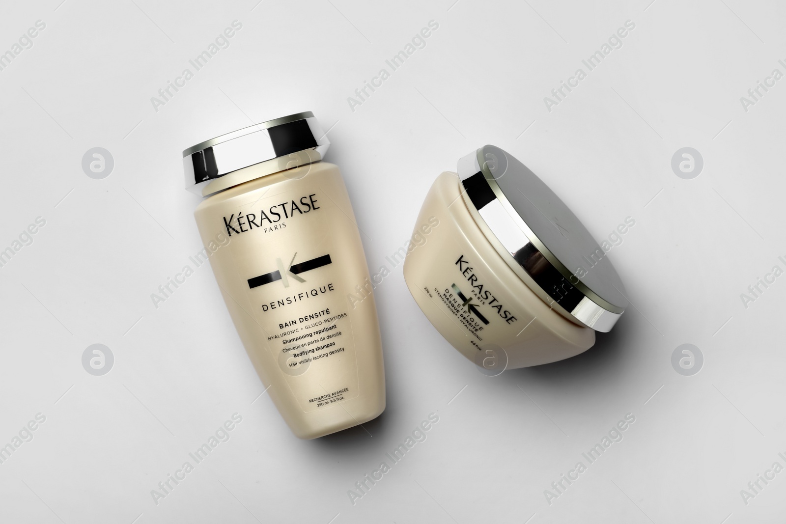 Photo of MYKOLAIV, UKRAINE - SEPTEMBER 07, 2021: Kerastase hair care cosmetic products on light background, flat lay