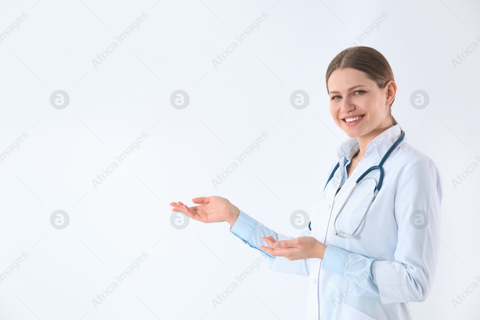 Photo of Portrait of young doctor against white background