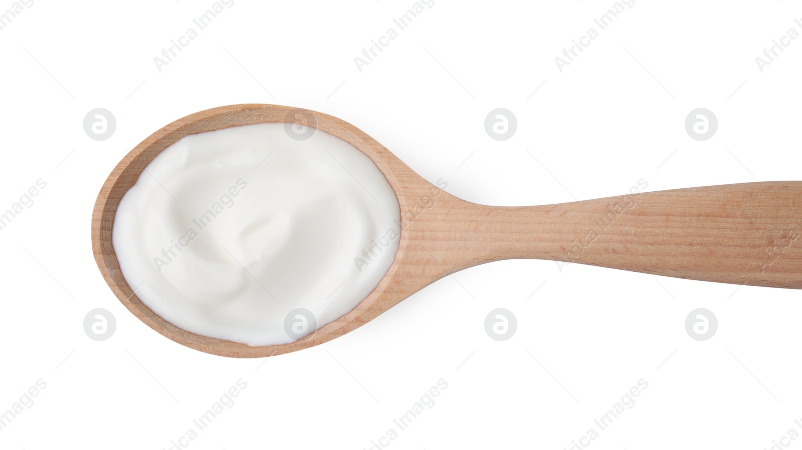 Photo of Delicious natural yogurt in wooden spoon isolated on white, top view