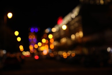 Photo of Blurred view of city street with lights at night. Bokeh effect