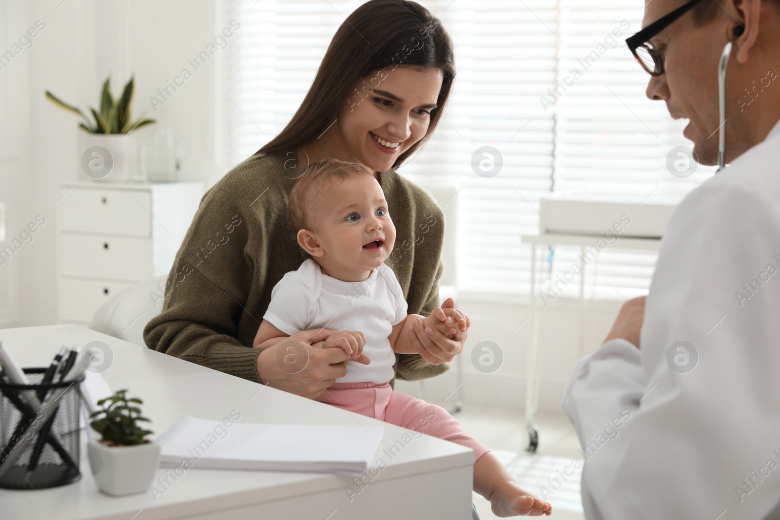 Photo of Mother with her cute baby visiting pediatrician in clinic