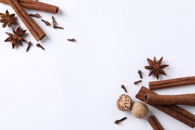 Different spices on white table, flat lay. Space for text