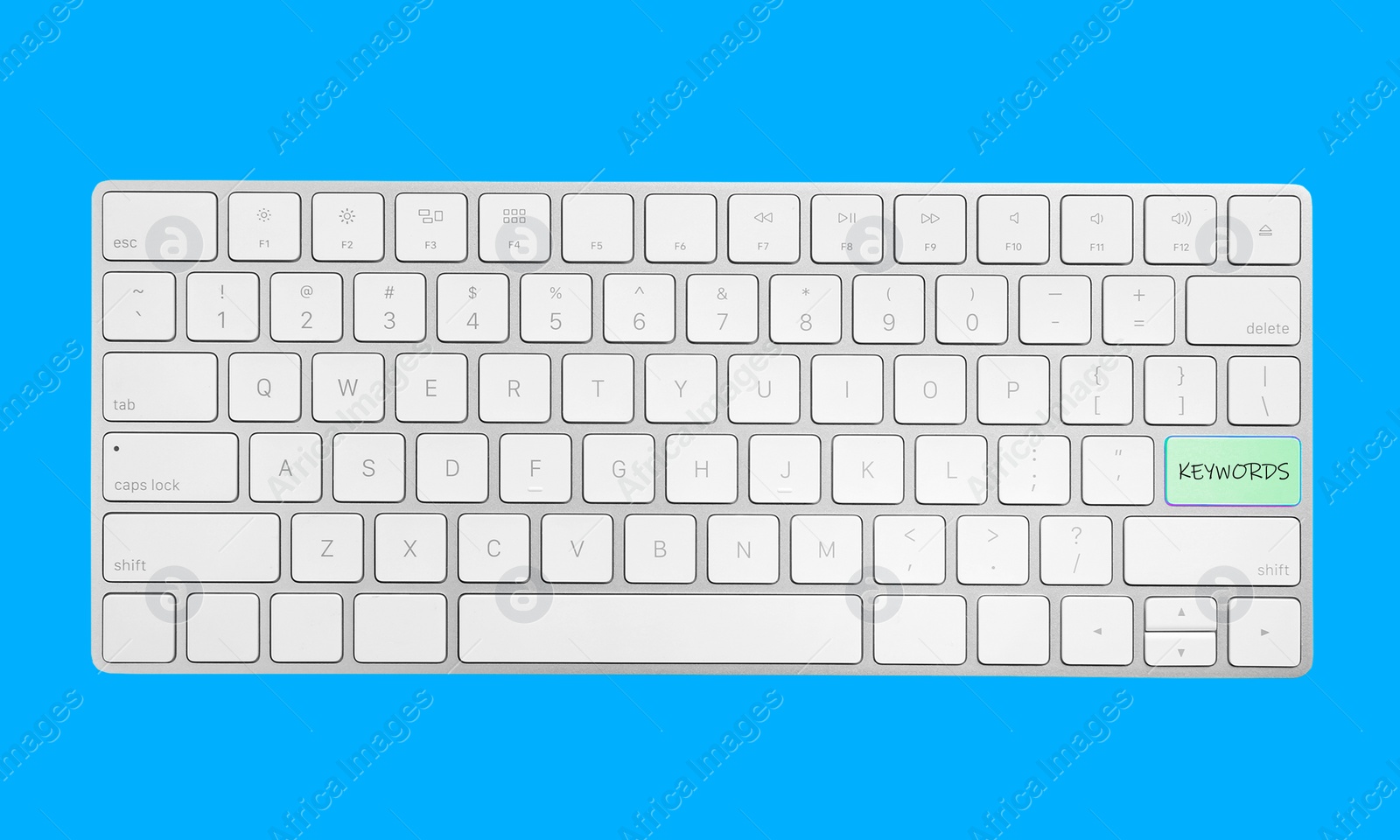 Image of Keyboard with text KEYWORDS on blue background, top view