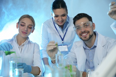 Group of scientists working in modern chemistry laboratory