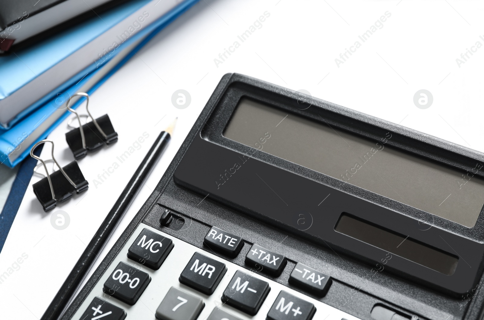 Photo of Calculator and stationery on table, closeup. Tax accounting
