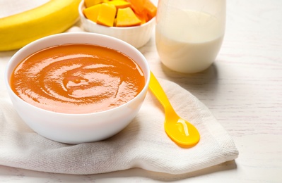 Photo of Healthy baby food on white wooden table