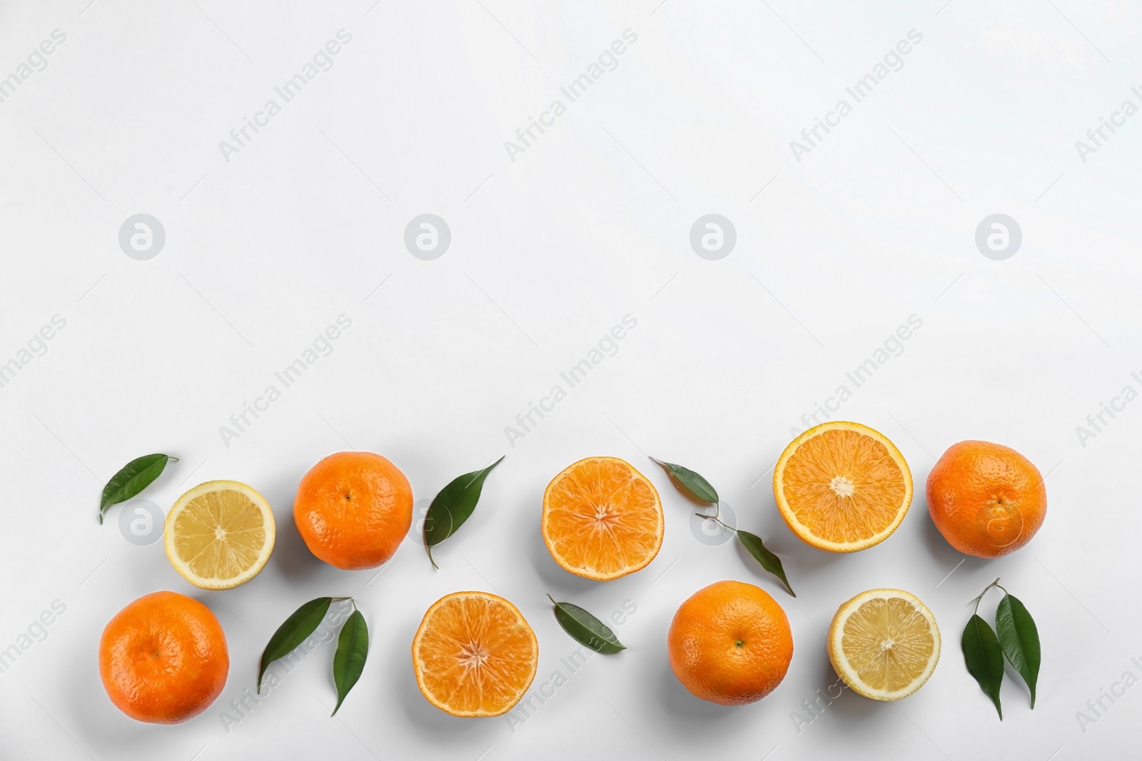 Photo of Flat lay composition with tangerines and lemons on white background. Space for text