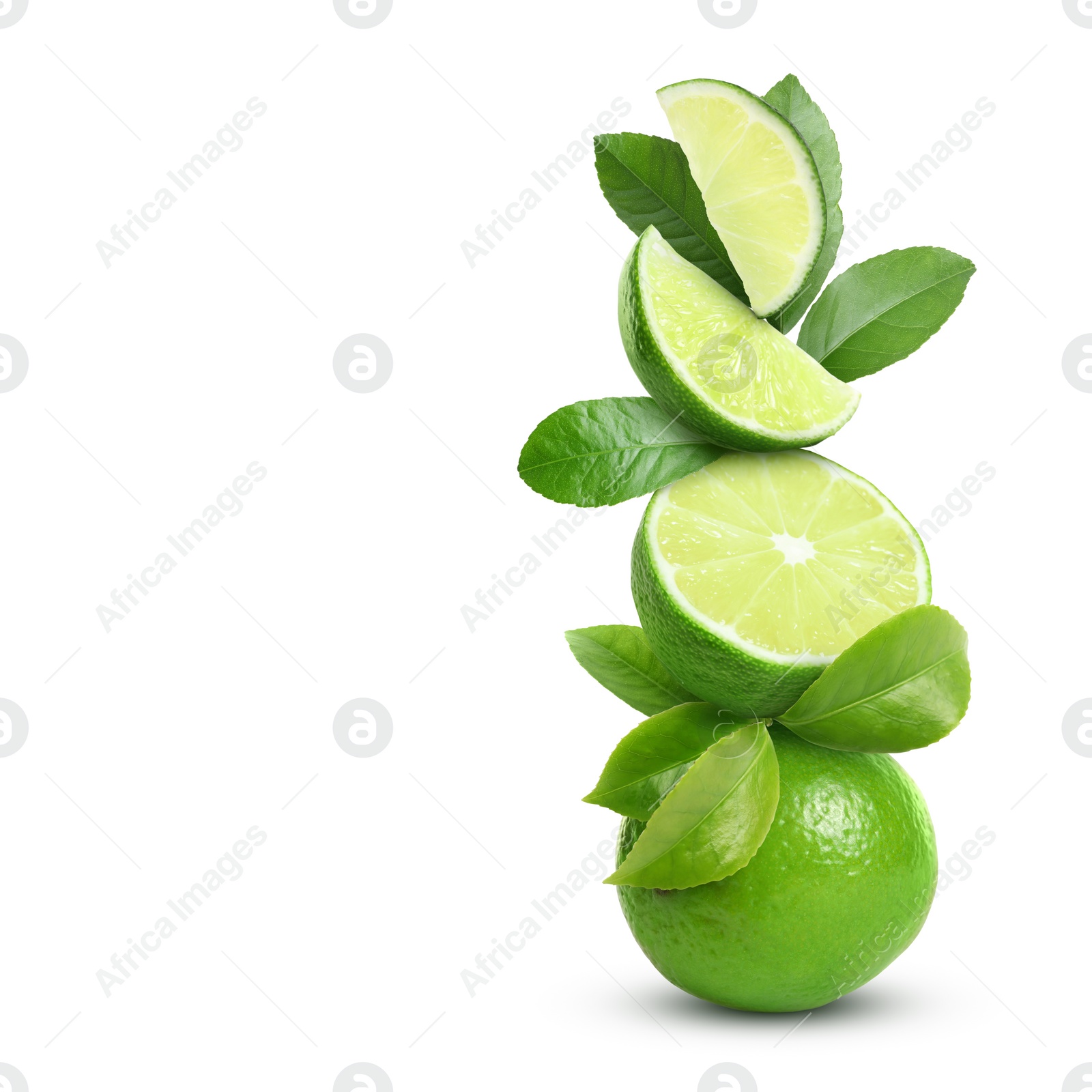 Image of Stacked cut and whole limes with gren leaves on white background