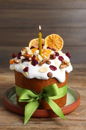 Photo of Tasty Easter cake with dried fruits and nuts on wooden table