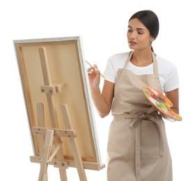 Photo of Young woman drawing on easel against white background