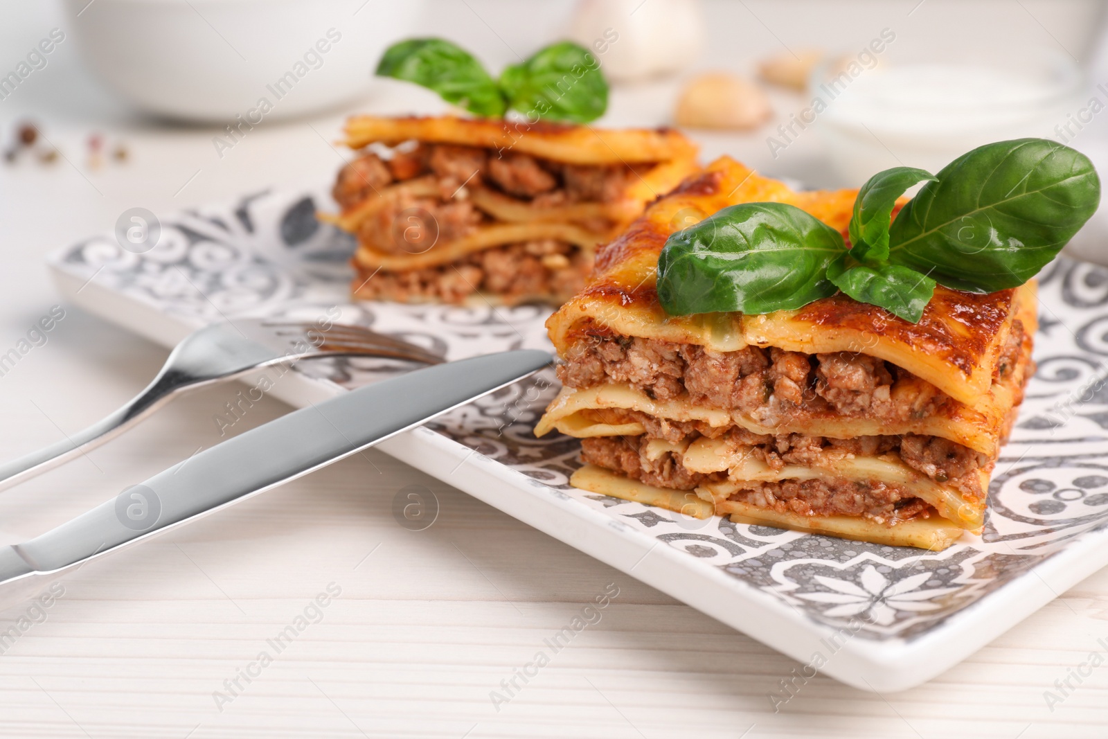 Photo of Delicious lasagna served on white table, closeup