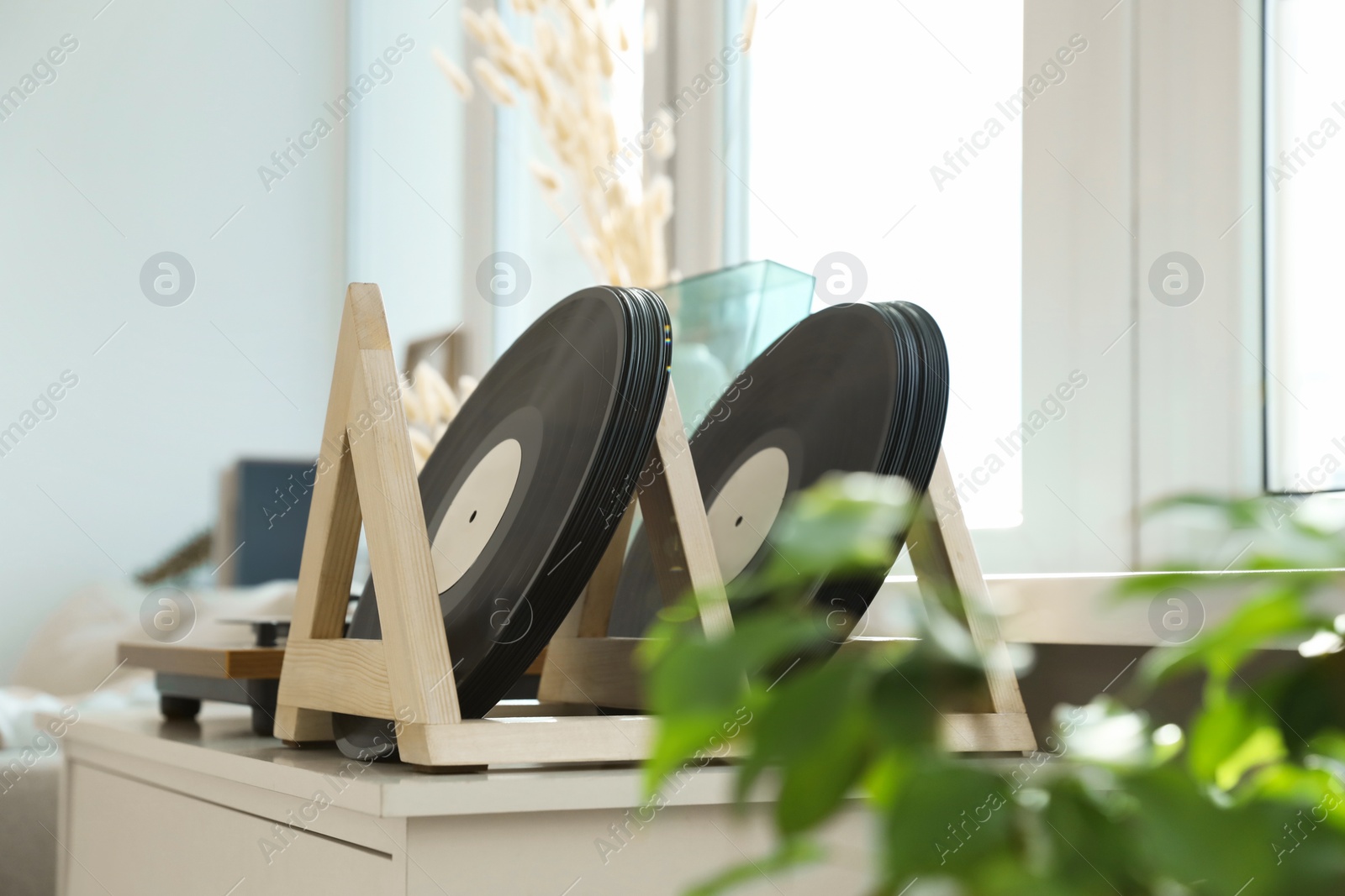 Photo of Vinyl records and player on white wooden table indoors