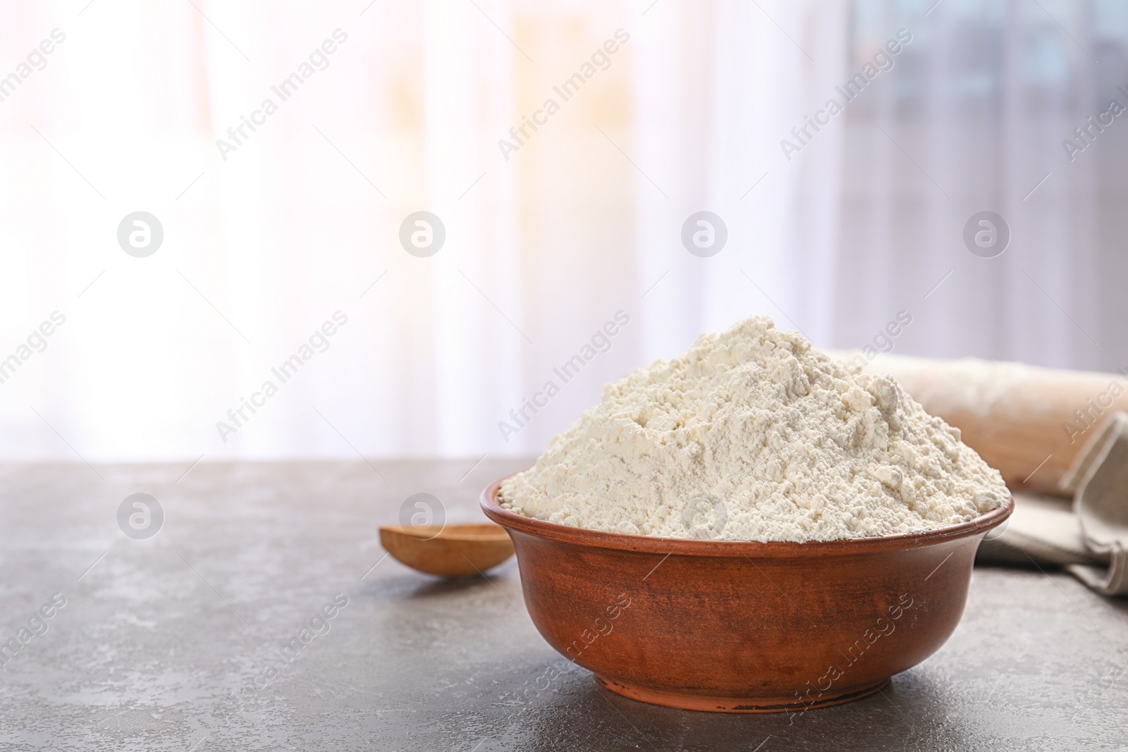 Photo of Bowl with flour on kitchen table