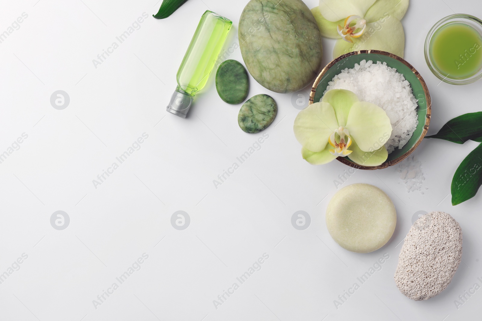 Photo of Flat lay composition with different spa products and beautiful flowers on white table. Space for text