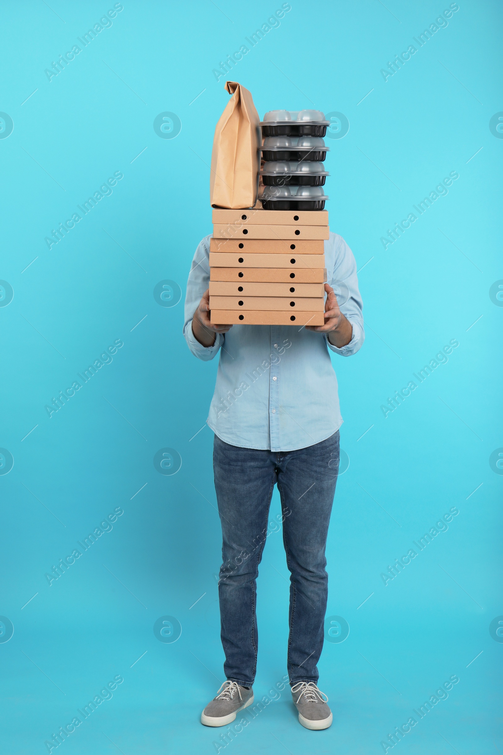 Photo of Courier with different orders on color background. Food delivery service