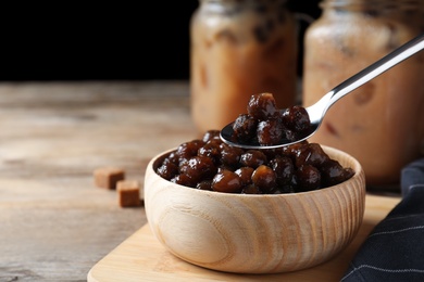 Tapioca balls for milk bubble tea on wooden table, closeup