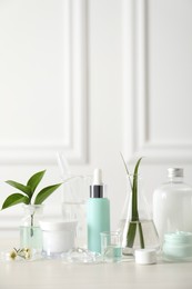 Natural ingredients for cosmetic products and laboratory glassware on white table