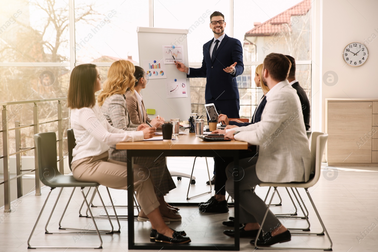 Photo of Businesspeople having meeting in office. Management consulting