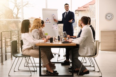 Photo of Businesspeople having meeting in office. Management consulting