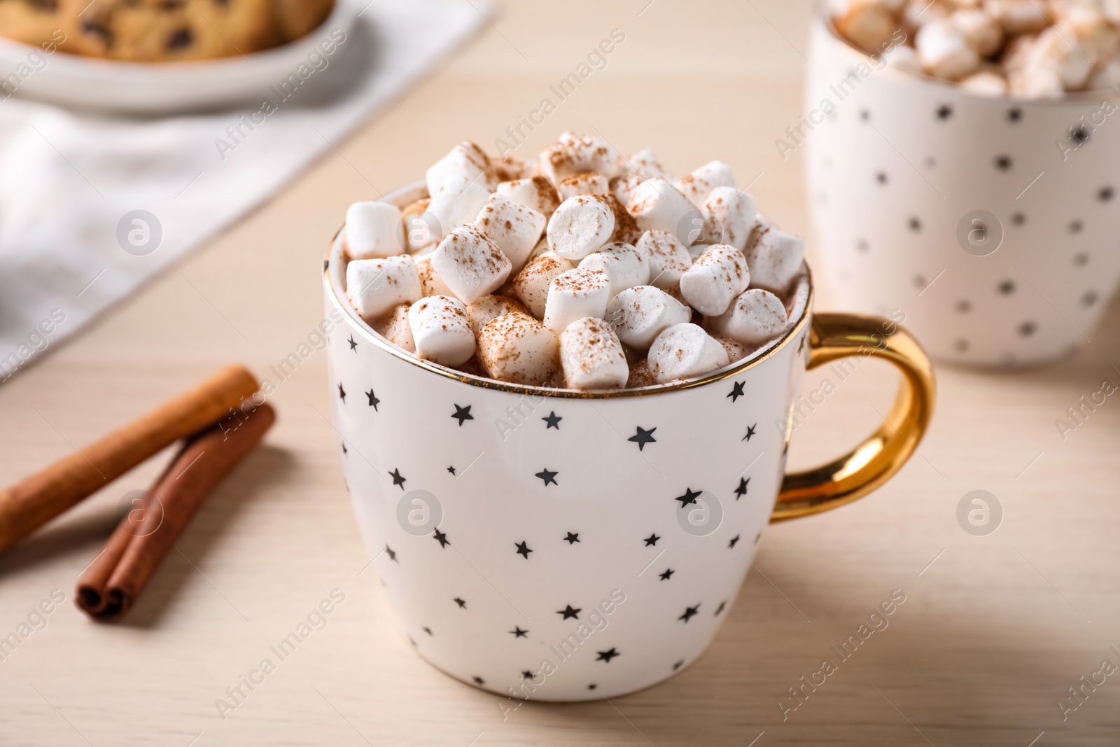 Photo of Cup of hot drink with marshmallows on wooden table